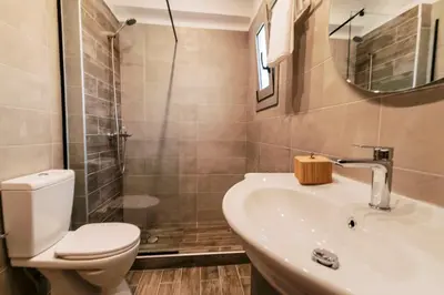 a bathroom with a toilet and a sink and a shower at Seascape House in Kremasti