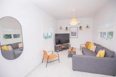 a living room with a couch and a tv at Villa Cervus Dianae in Kallithea Rhodes