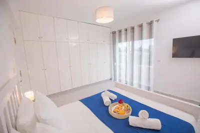 a room with a bed with a bowl of fruit on it at Villa Cervus Dianae in Kallithea Rhodes