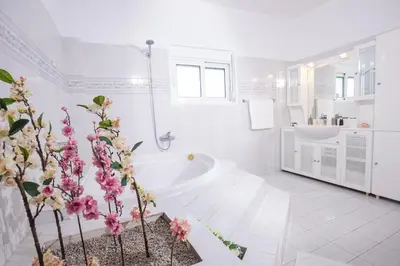 a white bathroom with a tub and a sink at Villa Cervus Dianae in Kallithea Rhodes