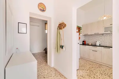 a kitchen with white cabinets and a white counter at Olympia's Cozy Guesthouse in Psinthos