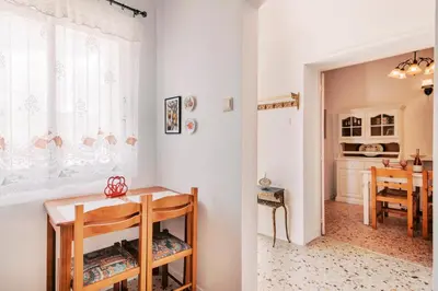 a living room with a table and a dining room at Olympia's Cozy Guesthouse in Psinthos