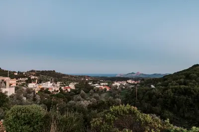 a view of a city from a hill with trees at Olympia's Cozy Guesthouse in Psinthos