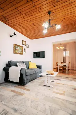 a living room with a couch and a table at Olympia's Cozy Guesthouse in Psinthos