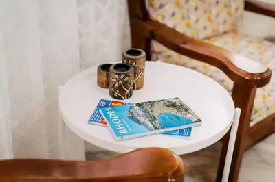 a white table with a book and a chair at Olympia's Cozy Guesthouse in Psinthos