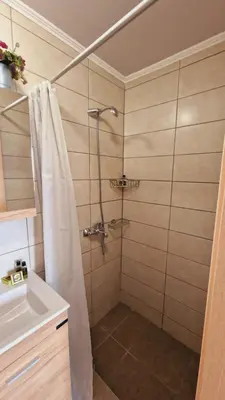a bathroom with a shower and a sink at Seva Monolithos house in Monólithos