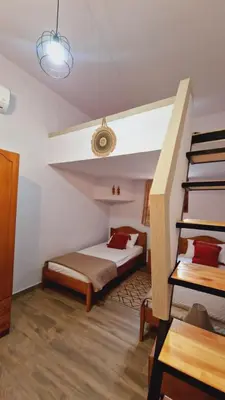 a bedroom with a bed and stairs in a room at Seva Monolithos house in Monólithos