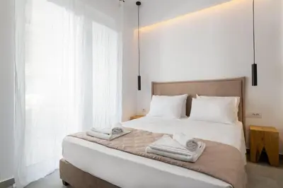 a bedroom with a bed with towels on it at Venthos Apartments in Kolimbia