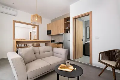 a living room with a couch and a table at Venthos Apartments in Kolimbia