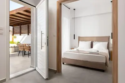 a bedroom with a bed and a mirror at Venthos Apartments in Kolimbia