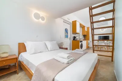 a bedroom with a bed with towels on it at Venthos Apartments in Kolimbia