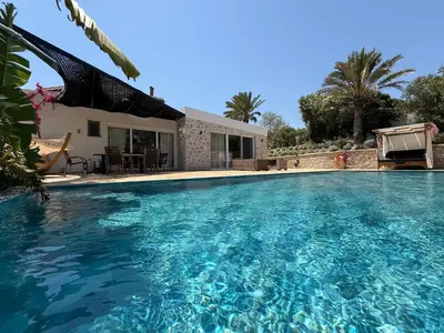 a swimming pool in front of a house at Gatsby Rhodes -Two Brand New Exclusive Villas in Asgourou