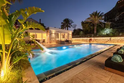 a swimming pool in front of a house at Gatsby Rhodes -Two Brand New Exclusive Villas in Asgourou