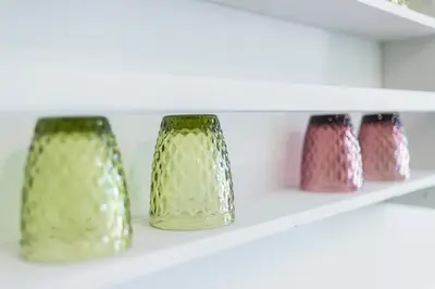 three vases are sitting on a shelf at LA CASA DI MARCONI in Symi