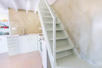 a staircase in a kitchen with a sink at LA CASA DI MARCONI in Symi