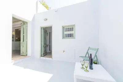 a white room with a white counter and two mirrors at LA CASA DI MARCONI in Symi