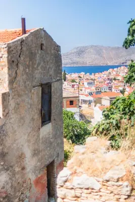 a building on a hill with a view of a city at LA CASA DI MARCONI in Symi