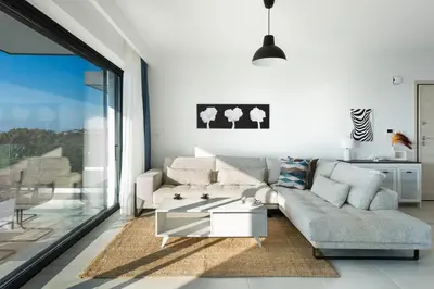 a living room with a couch and a table at Aquarama Pool Apartments in Ixia