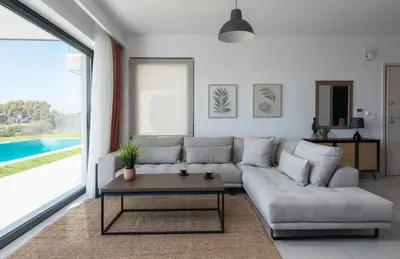 a living room with a couch and a table at Aquarama Pool Apartments in Ixia
