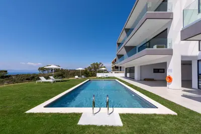 a swimming pool in front of a building at Aquarama Pool Apartments in Ixia