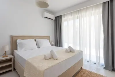 a bedroom with a bed with two towels on it at Aquarama Pool Apartments in Ixia
