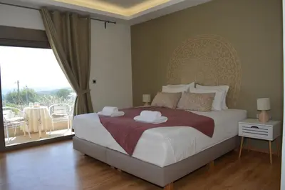 a bedroom with a large bed and a balcony at Home21 in Asgourou