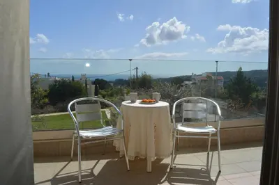 a table and chairs on a balcony with a view at Home21 in Asgourou