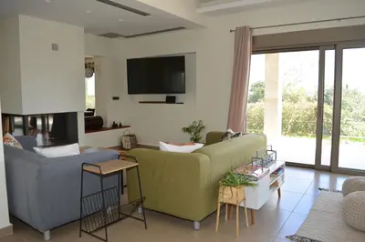 a living room with a couch and a tv at Home21 in Asgourou