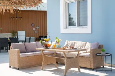 a living room with a couch and a table at Ethria Pool Villa with heated jacuzzi in Afantou