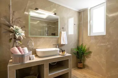 a bathroom with a sink and a mirror at Ethria Pool Villa with heated jacuzzi in Afantou