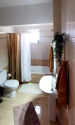 a bathroom with a toilet and a sink and a tub at Giotouli Apartment in Afantou