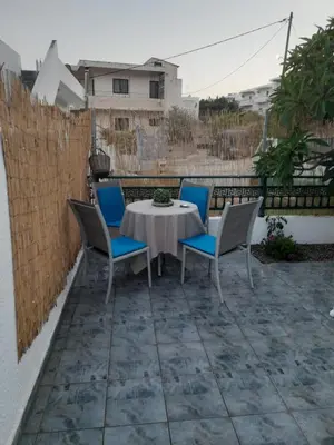 a table and chairs sitting on a patio at Giotouli Apartment in Afantou