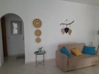 a living room with a couch and a table at Giotouli Apartment in Afantou