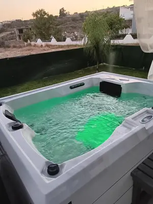 a bath tub with green water in it at GR House Eleftheria in Afantou