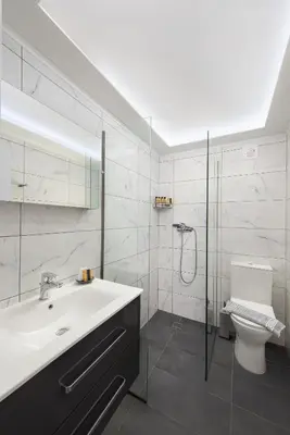 a bathroom with a sink and a shower and a toilet at GR House Eleftheria in Afantou