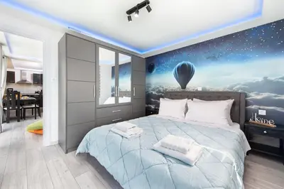 a bedroom with a large bed with a view of a hot air balloon at GR House Eleftheria in Afantou