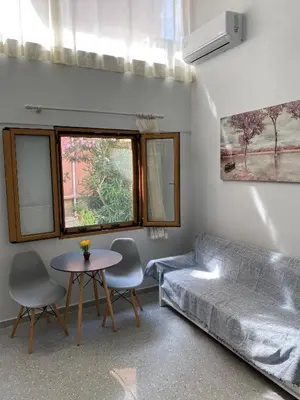 a living room with a couch and a table at Tête à Tête - Luxury Apartment in Rhodes Town