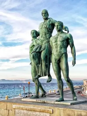 a statue of a man and two children standing next to the water at Tête à Tête - Luxury Apartment in Rhodes Town