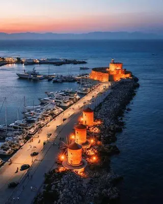 a dock with a bunch of boats in the water at Tête à Tête - Luxury Apartment in Rhodes Town