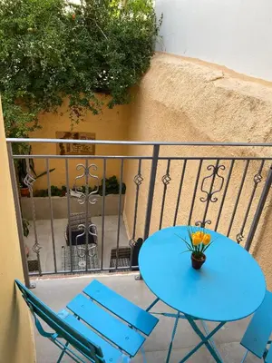 a blue table and chairs on a balcony at Tête à Tête - Luxury Apartment in Rhodes Town