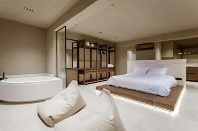 a bedroom with a bathtub and a bed and a bath tub at Sevasti Seaview Suite in Koskinou