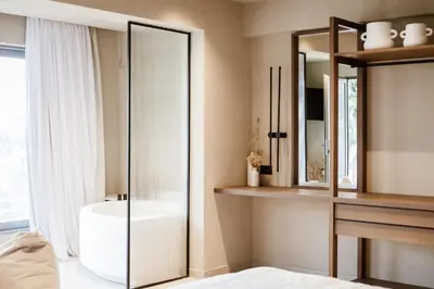 a bathroom with a glass shower and a sink at Sevasti Seaview Suite in Koskinou