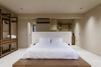 a bedroom with a large bed with white sheets at Sevasti Seaview Suite in Koskinou