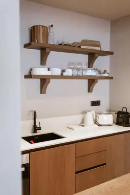 a kitchen with wooden cabinets and a counter top at Sevasti Seaview Suite in Koskinou