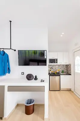 a kitchen with white cabinets and a white counter top at Sunwaves Beach studio I in Ialyssos