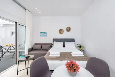 a living room with a bed and a couch at Sunwaves Beach studio II in Ialyssos