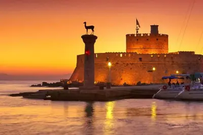 a castle with a statue of a kangaroo on a pole in front at Sunwaves Beach studio II in Ialyssos