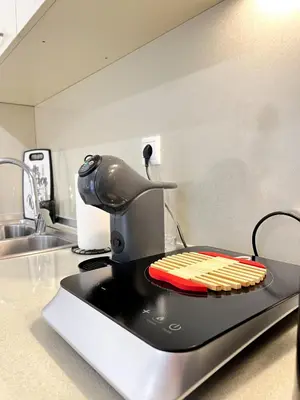 a kitchen counter with a microwave with some utensils at Haplotēs Rhodes Apartment in Koskinou