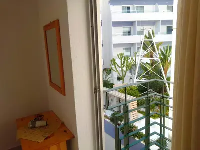 a room with a balcony with a view of a building at GT Apartment in Rhodes Town
