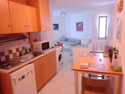 a kitchen with a table and a stove top oven at GT Apartment in Rhodes Town